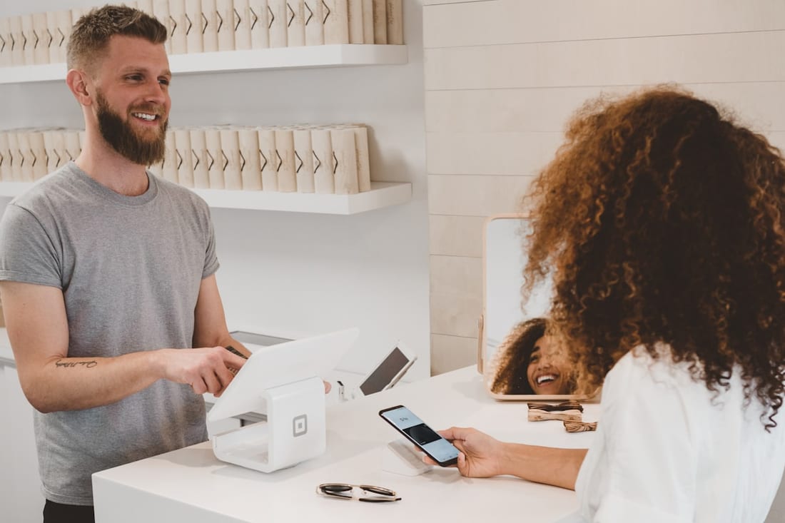 A customer paying at a shop counter.