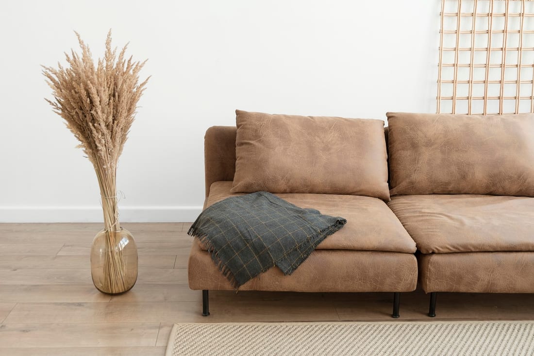 A furnished living room in daylight with visible everyday use.
