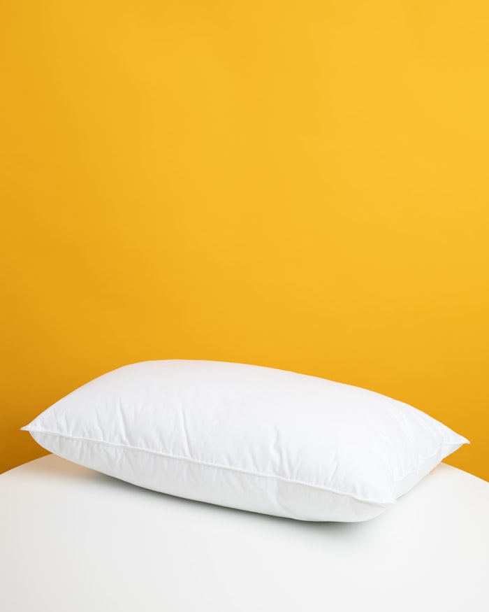 A cushion on upholstered furniture, photographed close.